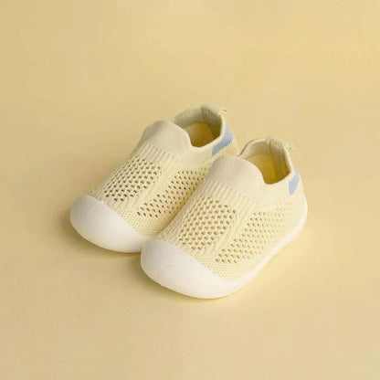 Cream mesh baby sneakers with breathable design for first steps
